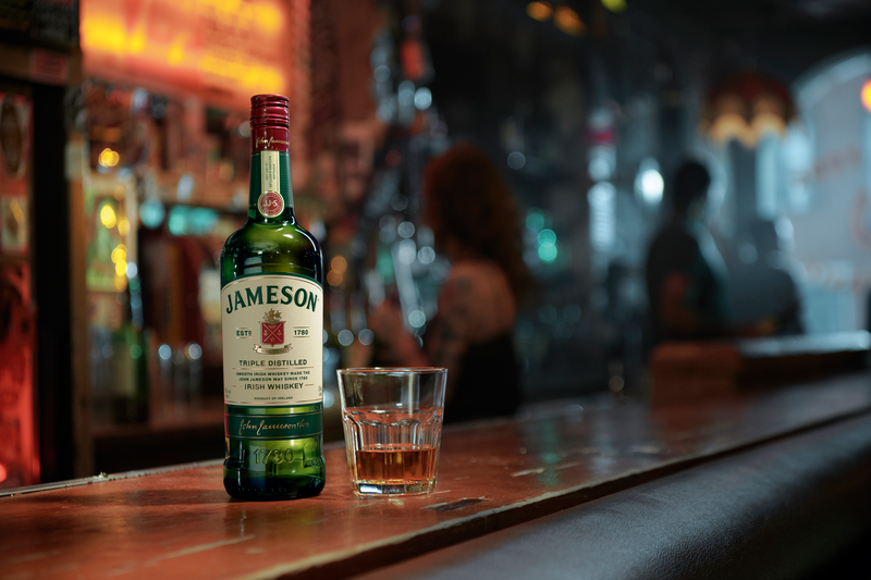 Jameson on the rocks serving beside a Jameson Irish Whiskey bottle
