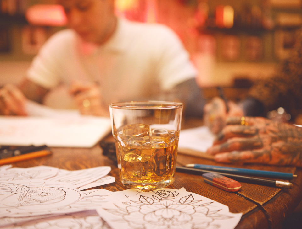 Jameson Irish Whiskey serving in a glass with friends sketching in the background