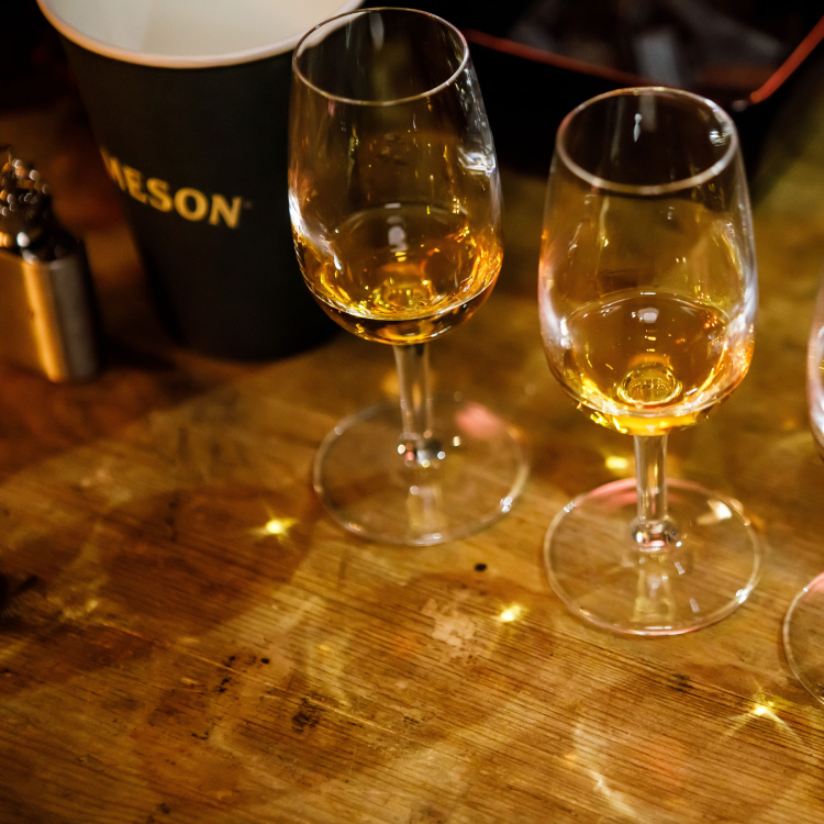 Group of whiskeys in copita-style glasses lined up for tasting