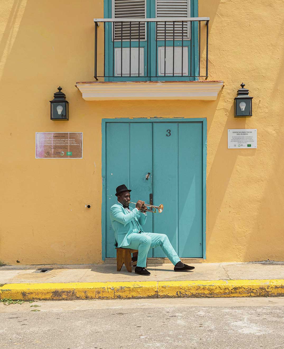 man playing the trumpet on the streets of havana