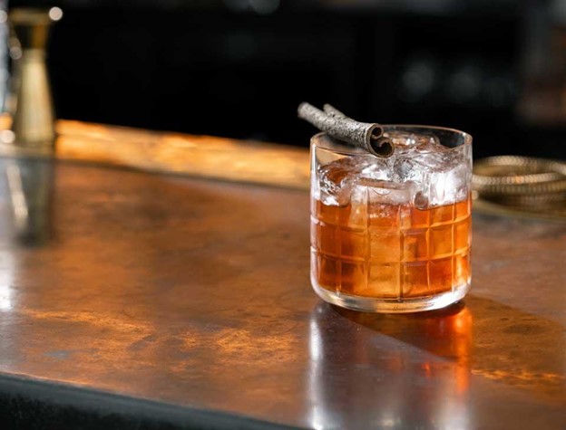 maple old fashioned made with jameson irish whiskey and garnished with cinnamon stick