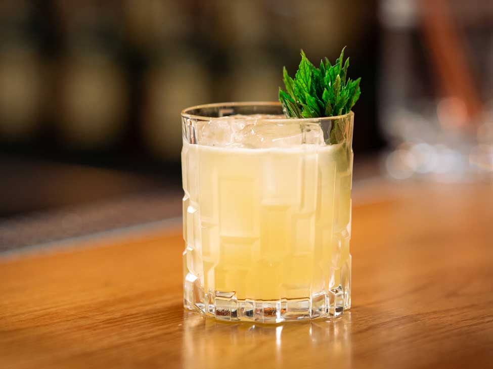Jameson Smash cocktail garnished with herbs