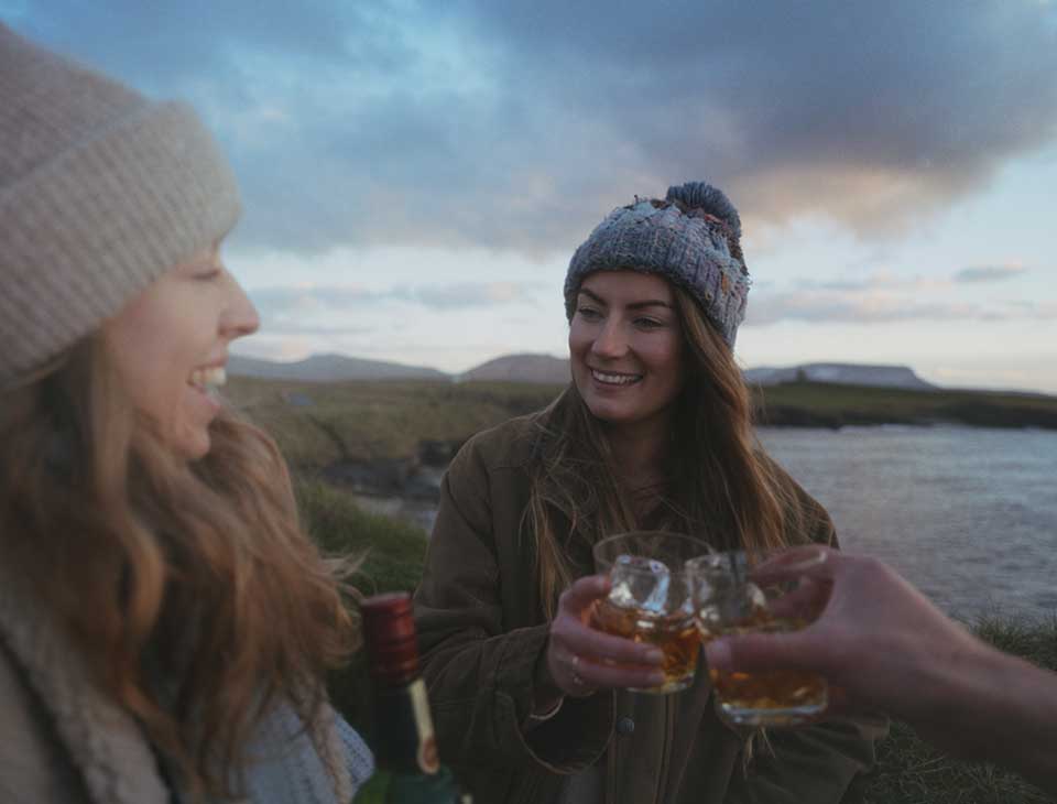 two pals enjoying smooth whiskey desktop